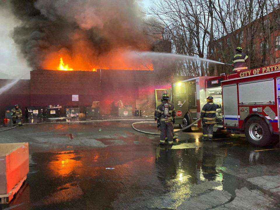 City of Paterson firefighters work to douse the flames from a fire that tore through the Pickle King factory on Ellison Street in Paterson early Saturday morning, March 25, 2023.