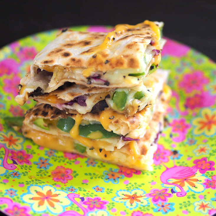 Snack on these dual cheese quesadillas paired with crunchy green capsicums and ground black pepper