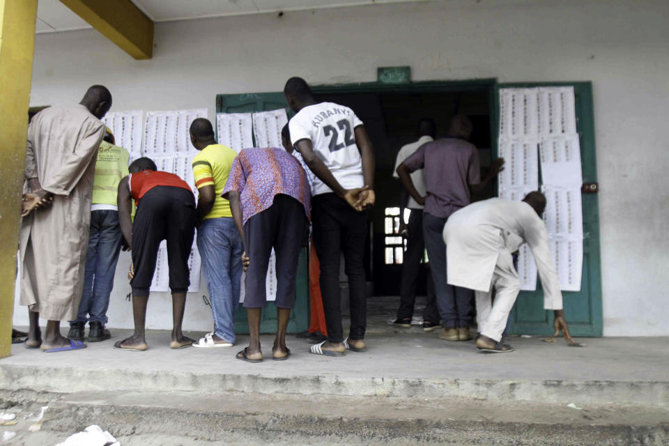 Malians living in the Ivory Coast, gather at a polling station before casting their ballot on a new Malian draft constitution, in Abidjan, Sunday, June 18, 2023. Malian voters cast ballots on a new draft constitution Sunday in a referendum that the country's coup leader says will pave the way toward holding new elections in 2024, but that critics have called a delaying tactic for him to extend his time in power. (AP Photo/Diomande Ble Blonde)