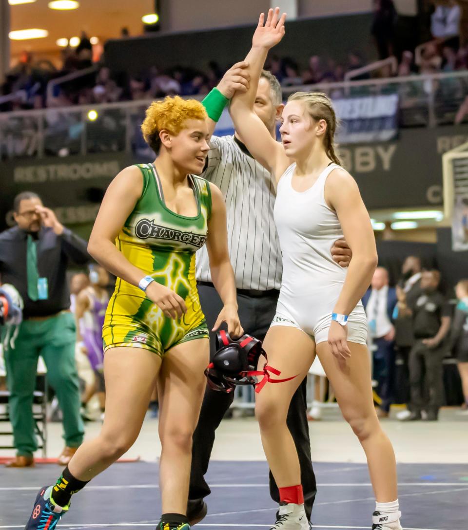 Milana Borrelli of Venice High has her hand raised after defeating Delialah Betances of Liberty High in the 120-pound weight class at the FHSAA Wrestling Championships on March 2 at Silver Spurs Arena in Kissimmee.