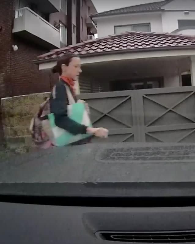 woman has been caught on a dash cam keying a luxury car. Source: Facebook / Evan Hansimikali