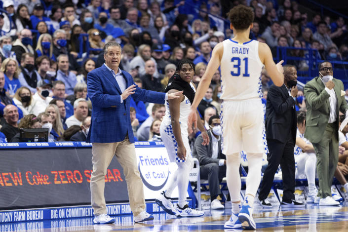 Kentucky head coach John Calipari, left, makes a substitution during the first half of an NCAA college basketball game against Mississippi State in Lexington, Ky., Tuesday, Jan. 25, 2022. (AP Photo/Michael Clubb)