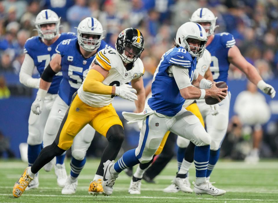Indianapolis Colts quarterback <a class="link " href="https://sports.yahoo.com/nfl/players/32010" data-i13n="sec:content-canvas;subsec:anchor_text;elm:context_link" data-ylk="slk:Gardner Minshew;sec:content-canvas;subsec:anchor_text;elm:context_link;itc:0">Gardner Minshew</a> II (10) scrambles with the ball as Pittsburgh Steelers linebacker <a class="link " href="https://sports.yahoo.com/nfl/players/30143" data-i13n="sec:content-canvas;subsec:anchor_text;elm:context_link" data-ylk="slk:T.J. Watt;sec:content-canvas;subsec:anchor_text;elm:context_link;itc:0">T.J. Watt</a> (90) gives chase Saturday, Dec. 16, 2023, during a game against the Pittsburgh Steelers at Lucas Oil Stadium in Indianapolis.