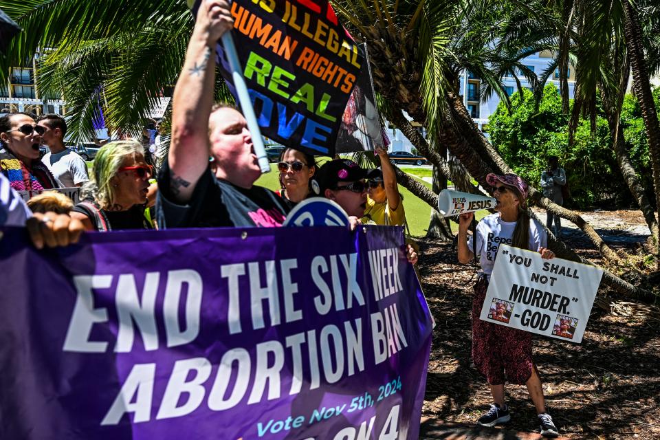 Anti-abortion activists (R) protest near the "Rally for Our Freedom" to protect abortion rights for Floridians, in Orlando, Florida, on April 13, 2024. Florida Rising, Floridians Protecting Freedom, and coalition partners officially launched the "Yes on 4" campaign. Florida's Supreme Court on April 1, 2024, paved the way for a ban on abortion after just six weeks of pregnancy, even as it allowed Amendment 4, protecting abortion rights, to be on the ballot in the November 2024 election. (Photo by CHANDAN KHANNA / via Getty Images)