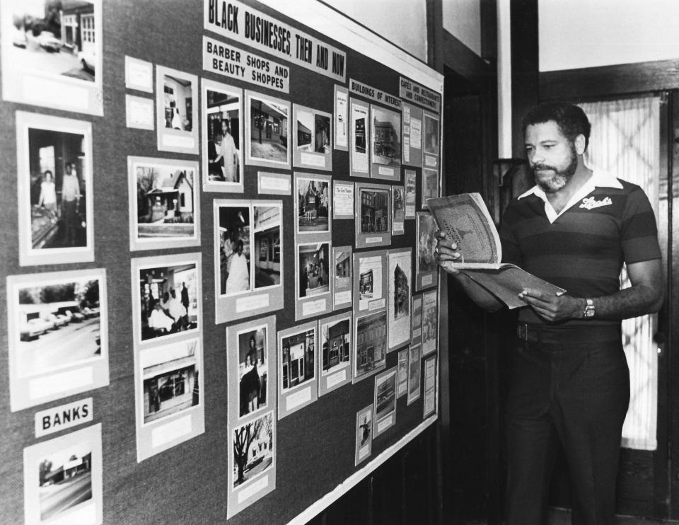 In a photograph published Aug. 6, 1978, Beck Cultural Exchange Center Executive Director Bob Booker poses at an exhibit about Black-owned businesses.