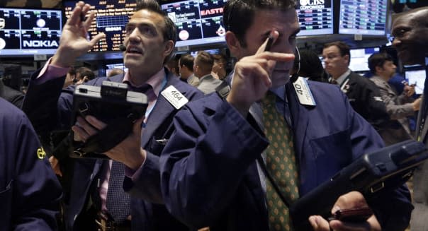 APTOPIX Wall Street (Traders Gregory Rowe, left, and Craig Spector work on the floor of the New York Stock Exchange, Friday, Oct