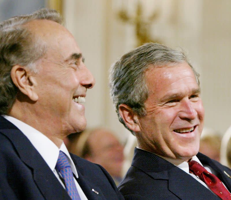 FILE PHOTO: U.S. President George W. Bush sits with former U.S. Senator Bob Dole at the White House