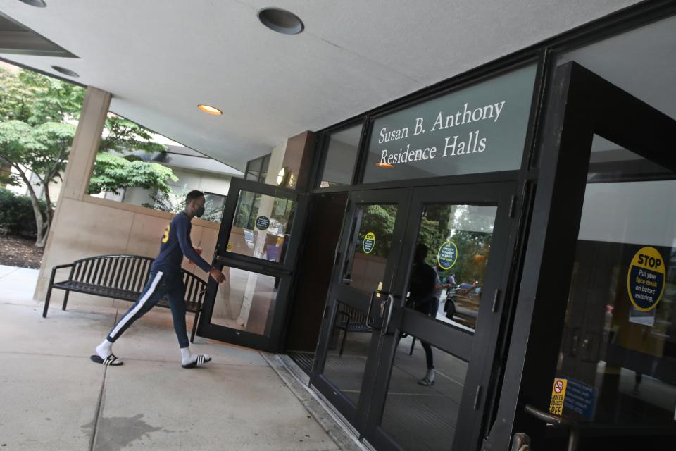 Yacine Sawadogo, a sophomore from Burkina Faso, heads into the Susan B. Anthony Residence Halls during the annual move-in day at the University of Rochester in New York.