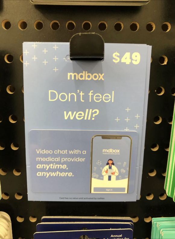 mdbox promotional display for $49 video medical consultations available anytime, anywhere. Features a phone screen showing a medical provider