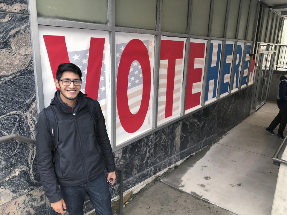 Minnesota Democratic-Farmer-Labor Party activist Manilan Houle, of Minneapolis, is the first person waiting in line outside a polling station in downtown Minneapolis on Friday, Sept. 21, 2018, on the first day of early voting in Minnesota in the 2018 midterm elections. Minnesota law allowed in-person voting to begin Friday — a full 46 days early — making it the first battleground state to begin casting actual votes in the broader fight for control of Congress. (AP Photo/Steve Karnowski)