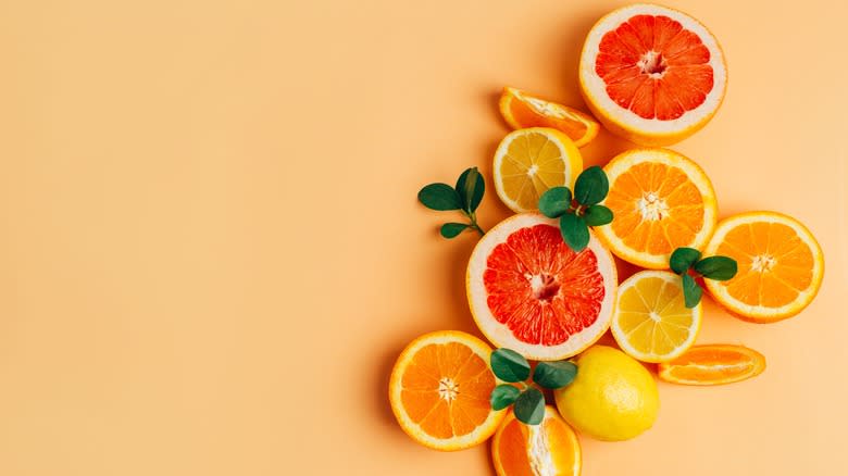 Citrus slices on orange background