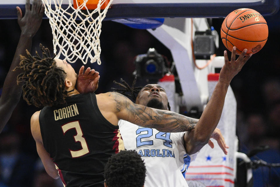 Florida State forward Cam Corhen (3) fouls North Carolina forward Jae'Lyn Withers (24) during the first half of an NCAA college basketball game in the quarterfinal round of the Atlantic Coast Conference tournament, Thursday, March 14, 2024, in Washington. (AP Photo/Nick Wass)