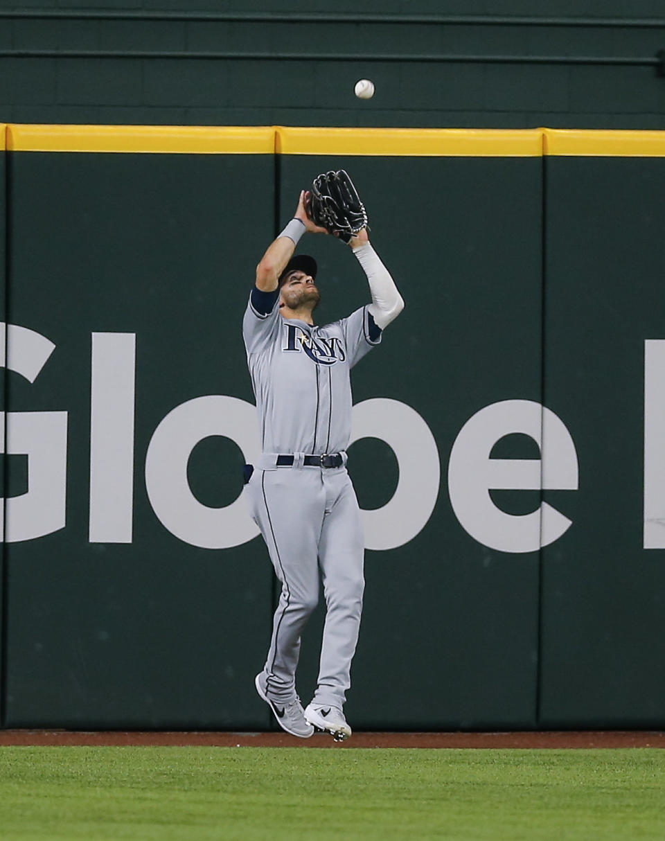 Tampa Bay Rays center fielder Kevin Kiermaier catches a flyout hit by Texas Rangers' Nate Lowe during the fifth inning of a baseball game, Saturday, June 5, 2021, in Arlington, Texas. (AP Photo/Brandon Wade)