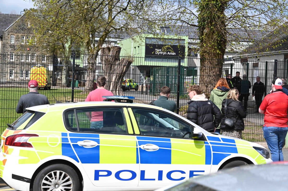 Parents waited outside the school gates for their children to be allowed to leave, with the school said to be in ‘code red’ (Robert Melen/Shutterstock)