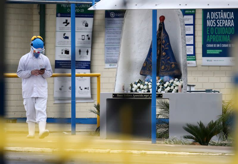 An employee of the JBS SA poultry factory walks after the company was hit by an outbreak of the coronavirus disease (COVID-19), in Passo Fundo