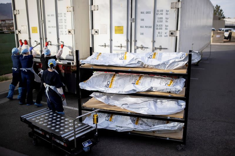 FILE PHOTO: El Paso County Medical Examiner's Office staff help move bodies in El Paso