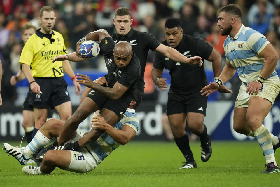 New Zealand's Mark Telea is brought down by Argentina's Agustin Creevy during the Rugby World Cup semifinal match between Argentina and New Zealand at the Stade de France in Saint-Denis, outside Paris, Friday, Oct 20, 2023. (AP Photo/Christophe Ena)