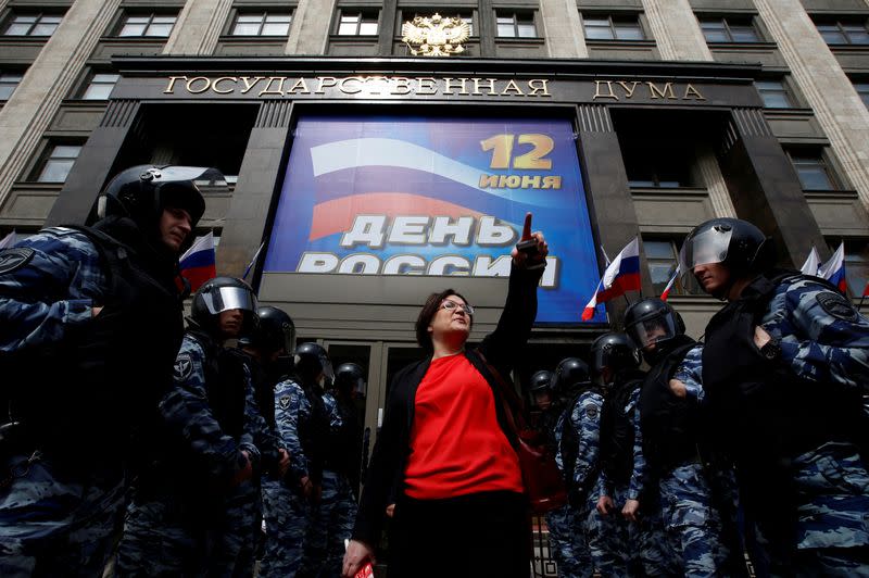 FILE PHOTO: Activist Galyamina is surrounded by police during a picket against a renovation law under the Moscow government’s renovation plan in front of the State Duma in Moscow