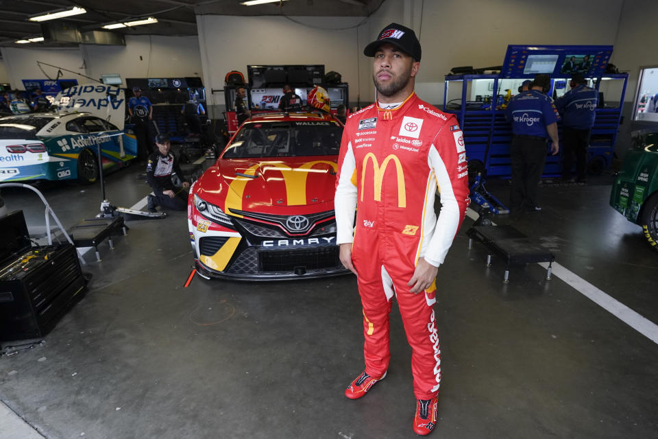 Bubba Wallace looks out from his garage before the start of a NASCAR auto race practice at Daytona International Speedway, Tuesday, Feb. 15, 2022, in Daytona Beach, Fla. (AP Photo/John Raoux)