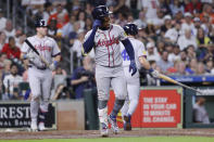 Atlanta Braves' Ozzie Albies limps to first base after getting hit by a pitch in the foot, allowing their second scoring run against the Houston Astros during the second inning of a baseball game Monday, April 15, 2024, in Houston. (AP Photo/Michael Wyke)