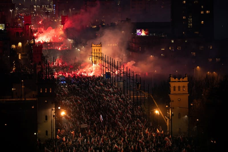 People burn flares during a march marking the National Independence Day in Warsaw