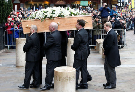 Pallbearers carry the coffin into Great St Marys Church, where the funeral of theoretical physicist Prof Stephen Hawking is being held, in Cambridge, Britain, March 31, 2018. REUTERS/Henry Nicholls