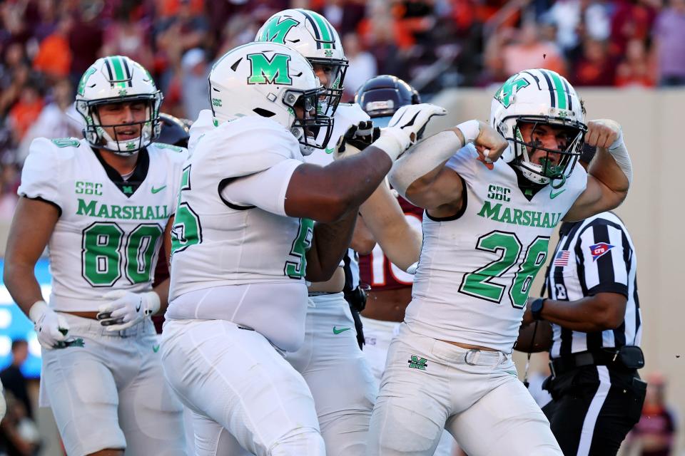 Marshall running back Ethan Payne (28) celebrates after scoring a touchdown against Virginia Tech.