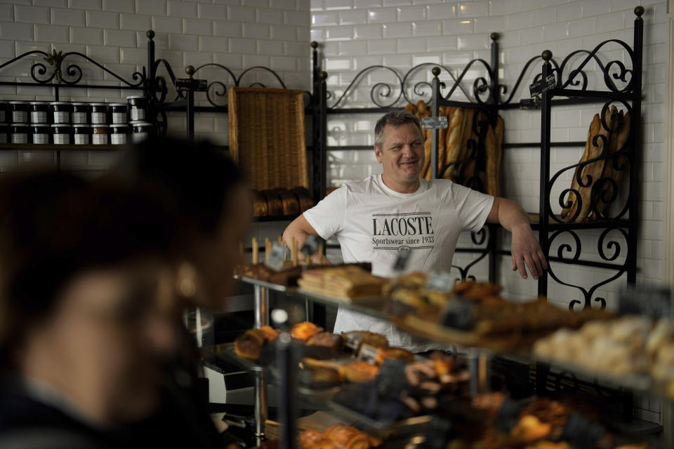 Owner of the "Modern bakery", Thierry Rabineau, poses for a picture, in Paris, Wednesday, April 19, 2023. The immense success of the Netflix series "Emily in Paris" has transformed a quiet, untouched square in the French capital into a tourist magnet. (AP Photo/Thibault Camus)