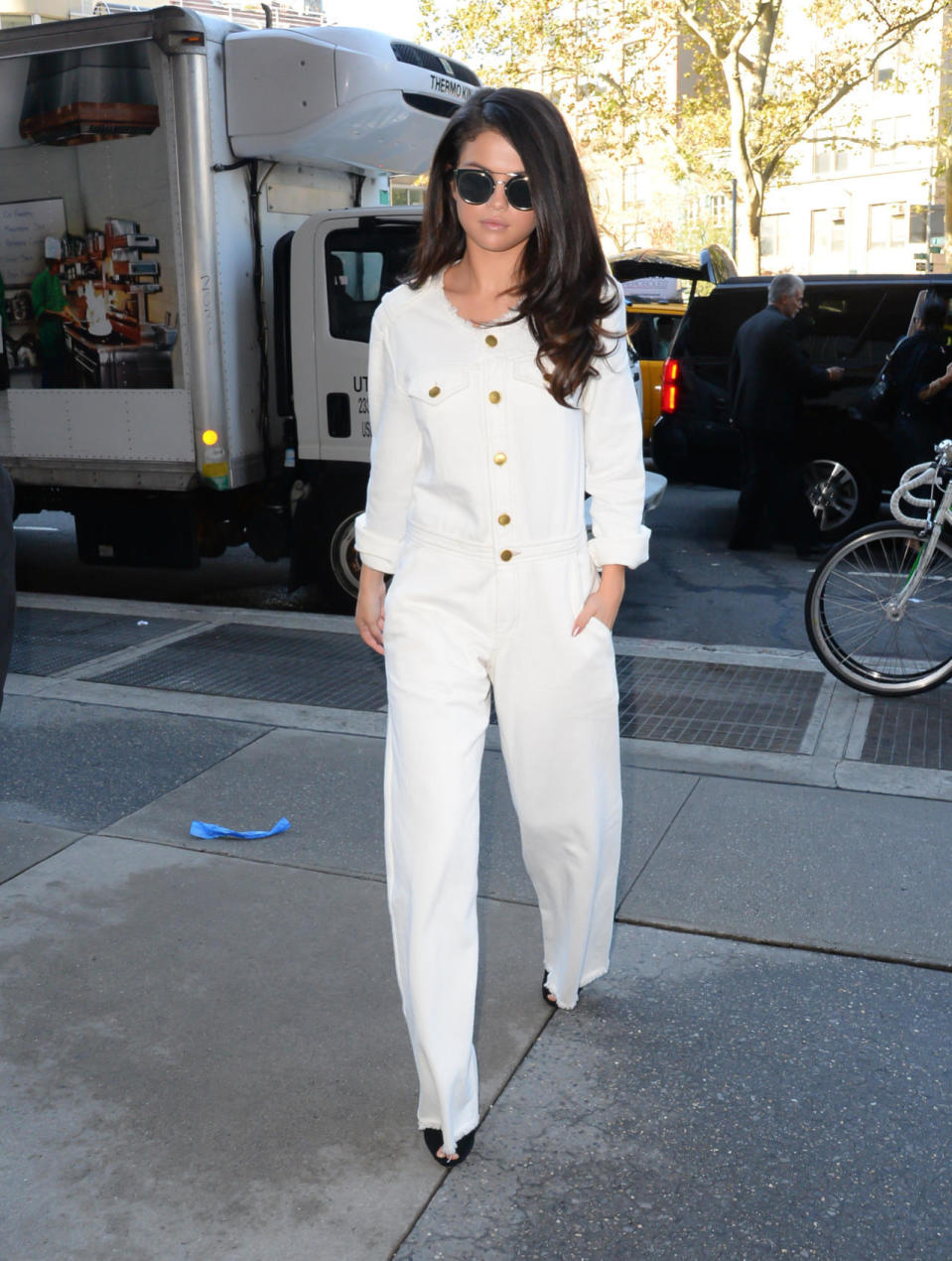 <p>Fashion rules be damned! When you have a white Isabel Marant jumpsuit with gold buttons that’s this chic, restricting its wear time to summer months just isn’t an option. The singer worked the statement piece with a pair of black Giuseppe Zanotti heels. <i>Photo: Getty Images</i></p>