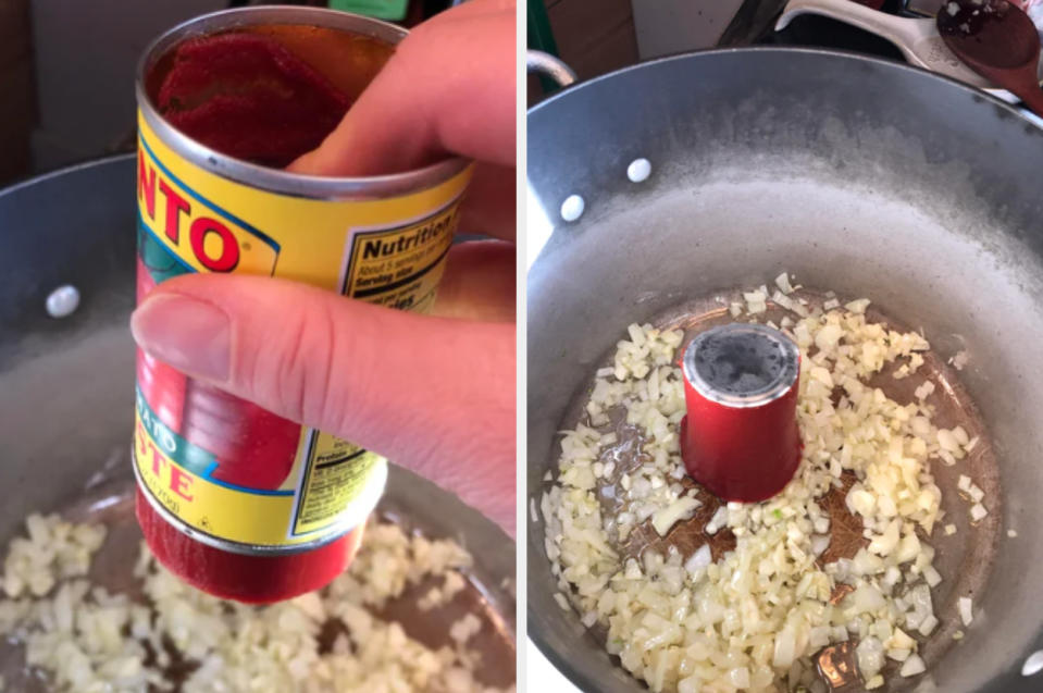 Someone pushing the tomato paste onto a skillet