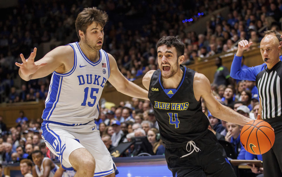 Delaware's Gianmarco Arletti (4) handles the ball as Duke's Ryan Young (15) defends during the first half of an NCAA college basketball game in Durham, N.C., Friday, Nov. 18, 2022. (AP Photo/Ben McKeown)
