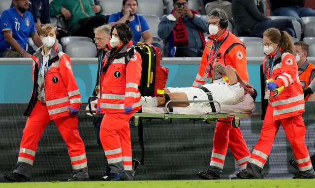 Italy’s Leonardo Spinazzola is carried off on a stretcher