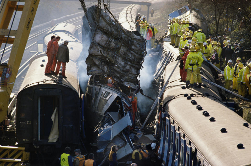 Firefighters and policemen work to free the dead and rescue the injured from the derailed carriages after a rail crash near Clapham Junction in London, December 1988. 35 people were killed and over 100 injured in the crash. (Photo by Tom Stoddart/Getty Images)