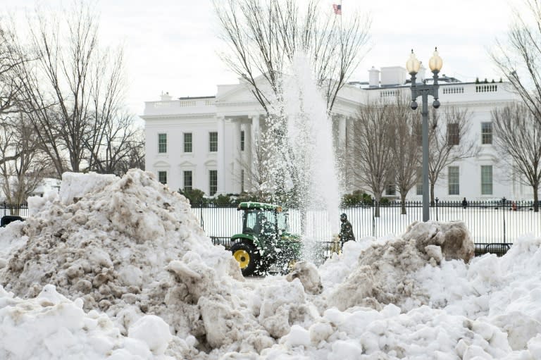 A snowblower clears Pennsylvania Avenue in front of the White House in Washington, DC, on January 26, 2016