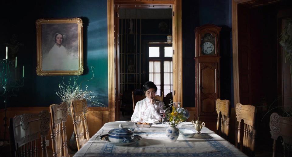 Mabel Cadena in Dance of the 41 sitting alone at a table