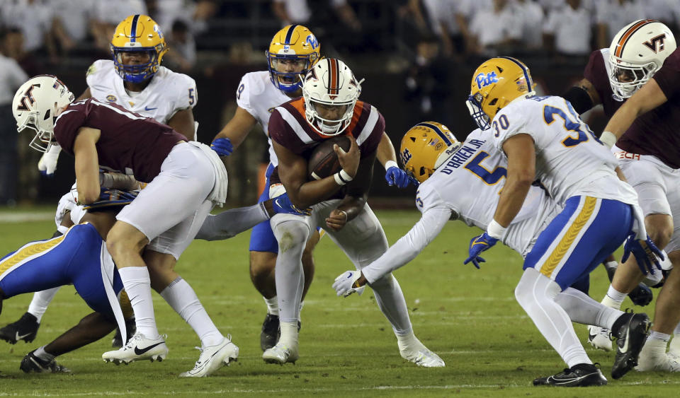 Virginia Tech quarterback Kyron Drones (1) runs for a first down against Pittsburgh during the first half of an NCAA college football game Saturday, Sept. 30, 2023, in Blacksburg, Va. (Matt Gentry/The Roanoke Times via AP)