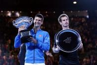 Tennis - Australian Open - Melbourne Park, Australia - 1/2/15 Mens Singles Final - Great Britain's Andy Murray looks dejected after defeat as Serbia's Novak Djokovic celebrates victory Action Images / Jason O'Brien Livepic