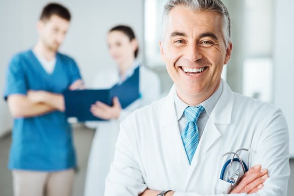 Smiling doctor with his arms crossed.