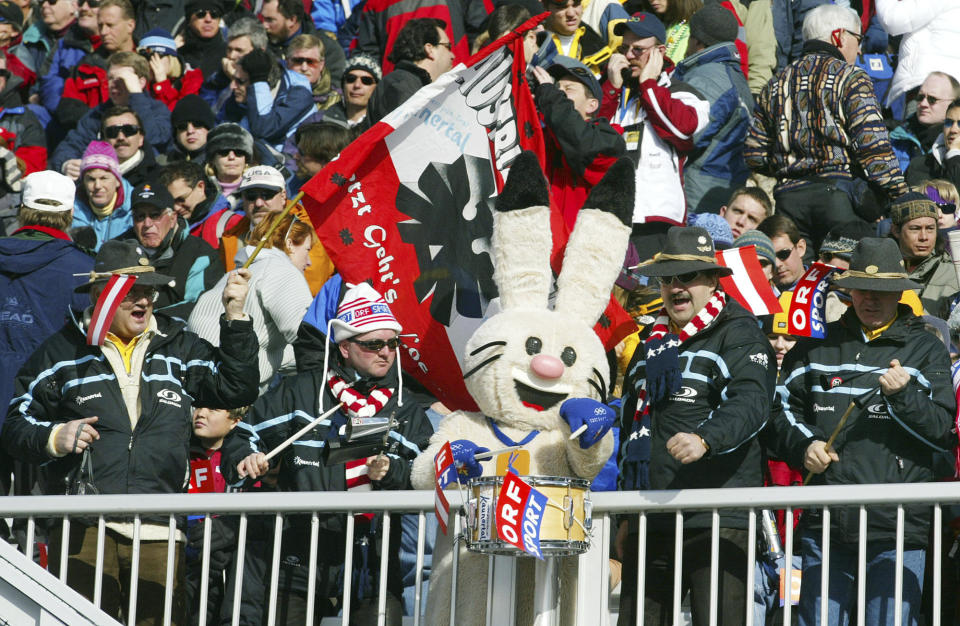 Supporters of the Austrian ski team make music with Powder one of the Salt Lake City Winter Olympic Games mascots as they wait for the start of the weather delayed women's downhill in Snowbasin, Utah on Feb. 11, 2002. (AP Photo/Rudi Blaha)