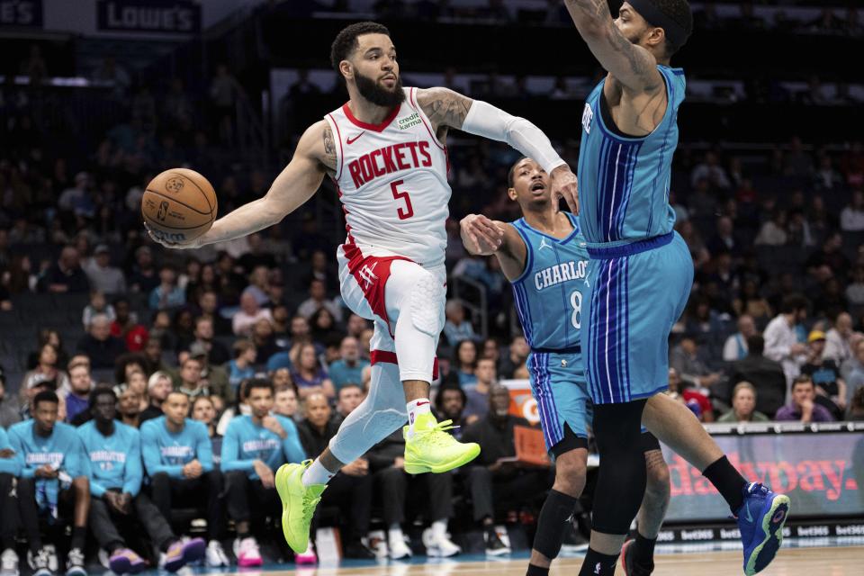 Houston Rockets guard Fred VanVleet (5) looks to pass while guarded by Charlotte Hornets forward Miles Bridges (0) during the first half of an NBA basketball game Friday, Jan. 26, 2024 in Charlotte, N.C. (AP Photo/Jacob Kupferman)