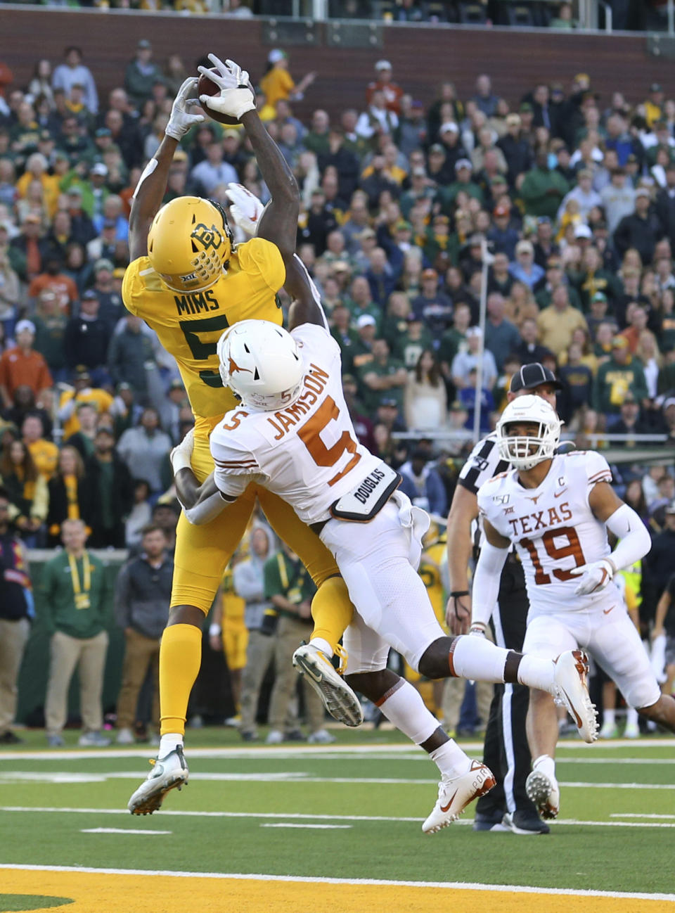 Baylor wide receiver Denzel Mims (5) makes a touchdown reception over Texas defensive back D'Shawn Jamison (5) in the third quarter in an NCAA college football game Saturday, Nov. 23, 2019, in Waco, Texas. (AP Photo/Richard W. Rodriguez)
