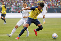 FILE - Ecuador defender Xavier Arreaga (14) controls the ball while defended by Mexico midfielder Jose Guardado (18) during the first half of an international friendly soccer match Sunday, June 5, 2022, in Chicago. (AP Photo/Jon Durr, File)