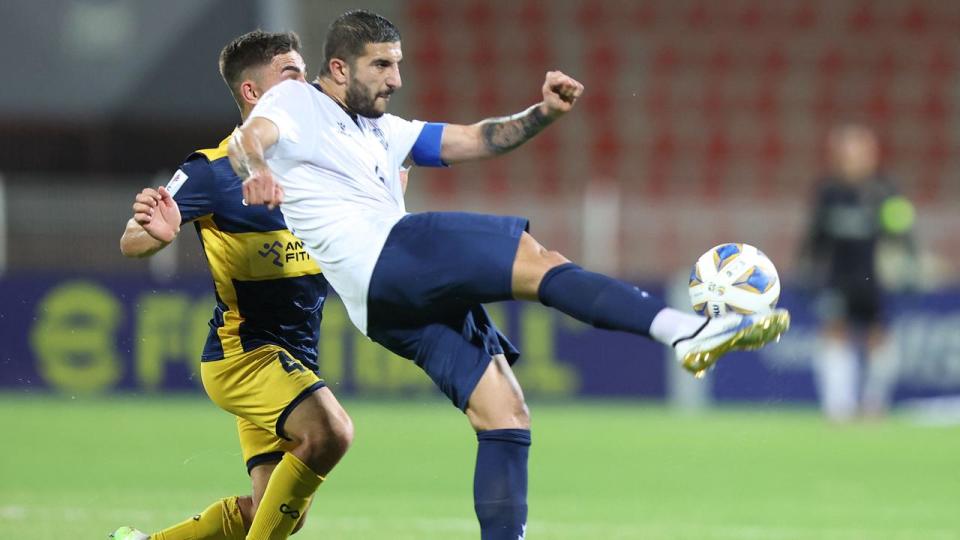 Mariners midfielder Josh Nisbet (left) battles with Al-Ahed defender Hussein Zein in the AFC Cup final. Picture: Haitham Al-Shukairi / AFP