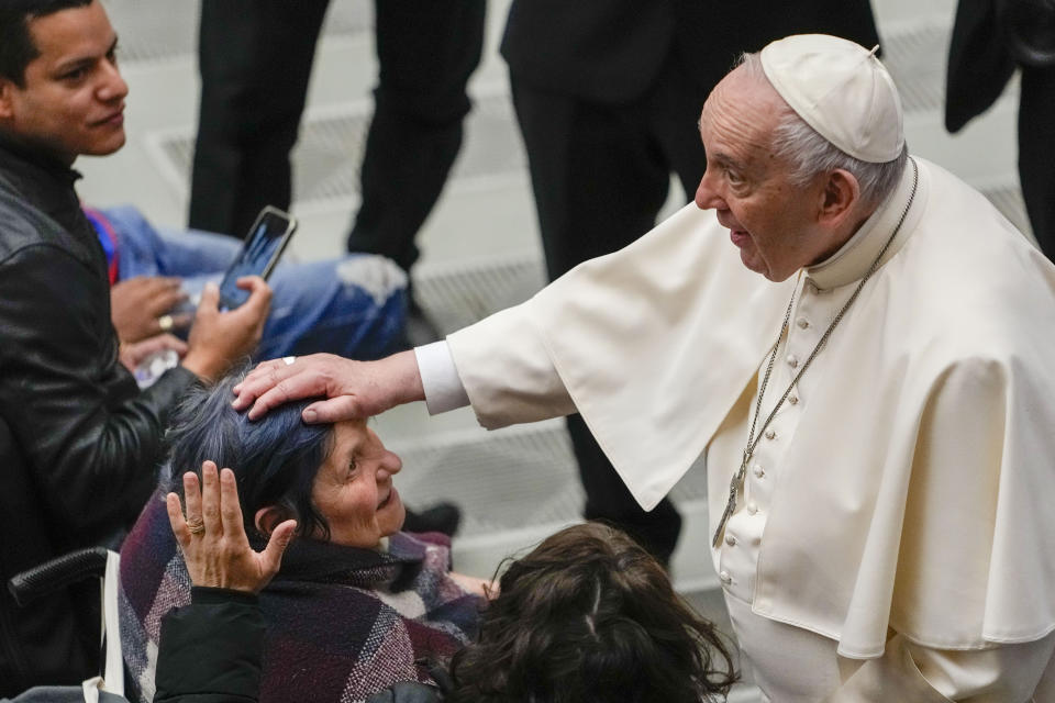 Pope Francis greets faithful at the end of his weekly general audience in the Paul VI Hall, at the Vatican, Wednesday, April 6, 2022. (AP Photo/Alessandra Tarantino)