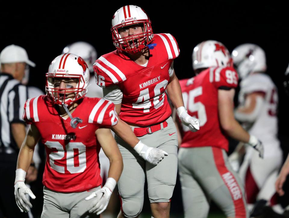Kimberly's Cody Obermann (20) and Sam Dudek (46) celebrate a goal line stand against Fond du Lac during their football game Friday in Kimberly.