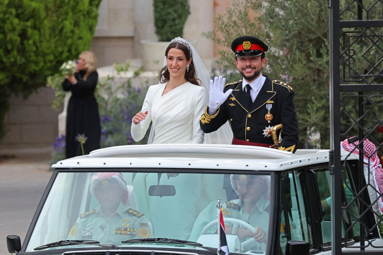 Jordan’s Crown Prince Hussein and his wife, Rajwa al-Seif, standing in a car following their wedding