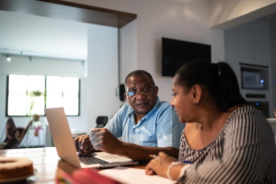 Adults looking at financial paperwork. 