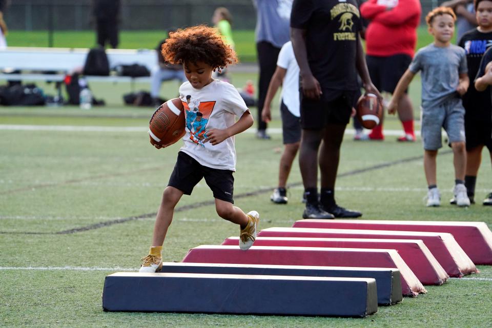 Young football players run drills during Paramus Catholic's annual TNT football camp on July 19, 2023, in Paramus.