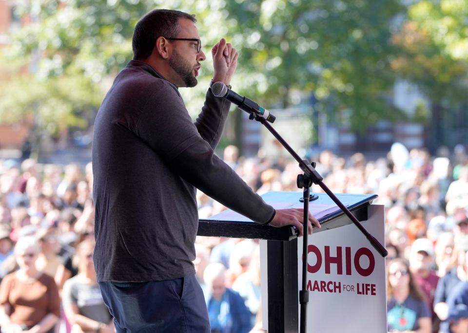 Aaron Baer, president of the Center for Christian Virtue, references Ohio's motto of "with God, all things are possible," during a rally and march from the Ohio Statehouse in downtown Columbus during the first Ohio March for Life on Wednesday. Barbara Perenic/Columbus Dispatch