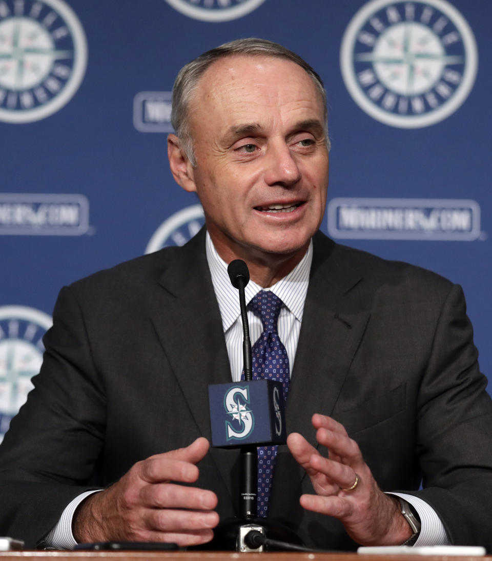 Baseball Commissioner Rob Manfred speaks to reporters before a baseball game between the Seattle Mariners and the Houston Astros on Tuesday, June 4, 2019, in Seattle. (AP Photo/Elaine Thompson)